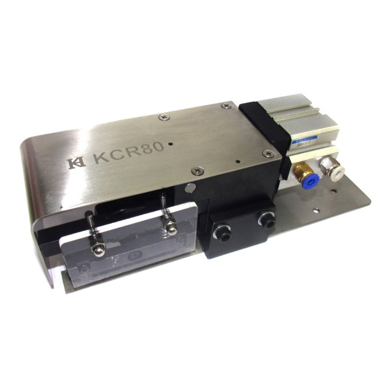 KCR-80 Pneumatic Cutter — Pneumatic Cutter (80mm Width) Can be used for cutting heavy duty, elastic, waistband, tape, spaghetti, etc. Even though several layers of denim or cross seams can be cut by the powerful pneumatic cutter. The cutter will automatically press and fix the tape position before cutting, in order to cut it straight. Manual cutting can be avoided by one button switching operation, saving time and the cost. The switch position can be adjusted by mounting the bracket. It can be mounted to the machine or place under the table as a knee switch. Can be used on flat bed machines.